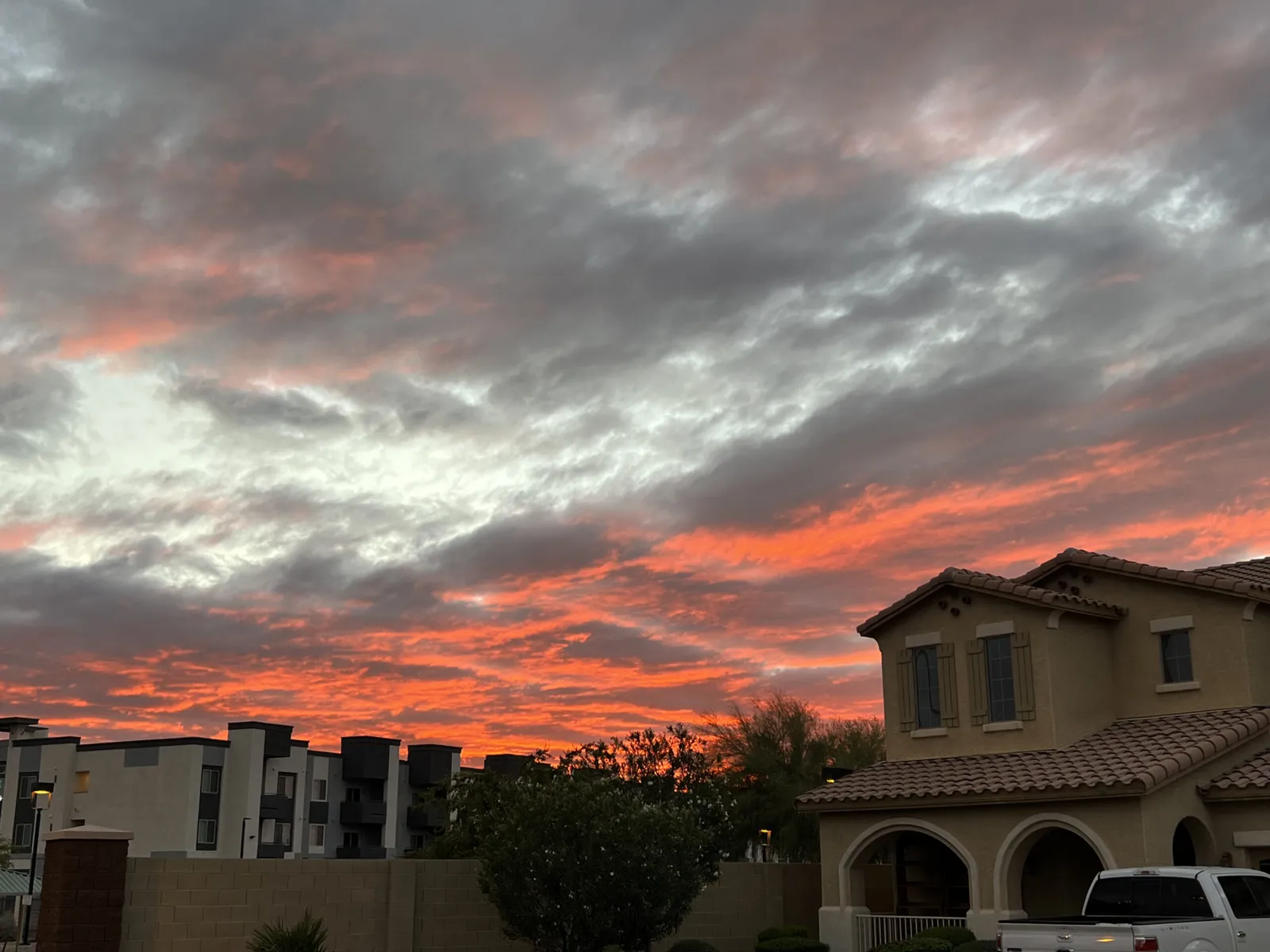 Storm clouds over West Valley rooftops at dusk